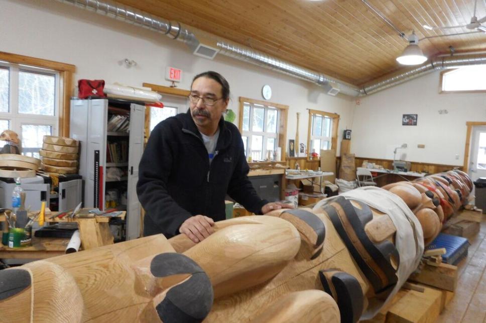 Artist Keith Wolfe Smarch displays the Learning Centre totem in the carving shed.  The goal of the carving shed is to preserve and carry on Carcross/Tagish First Nation stories and culture as well as teach people traditional skills (Photo: Samantha Dawson)